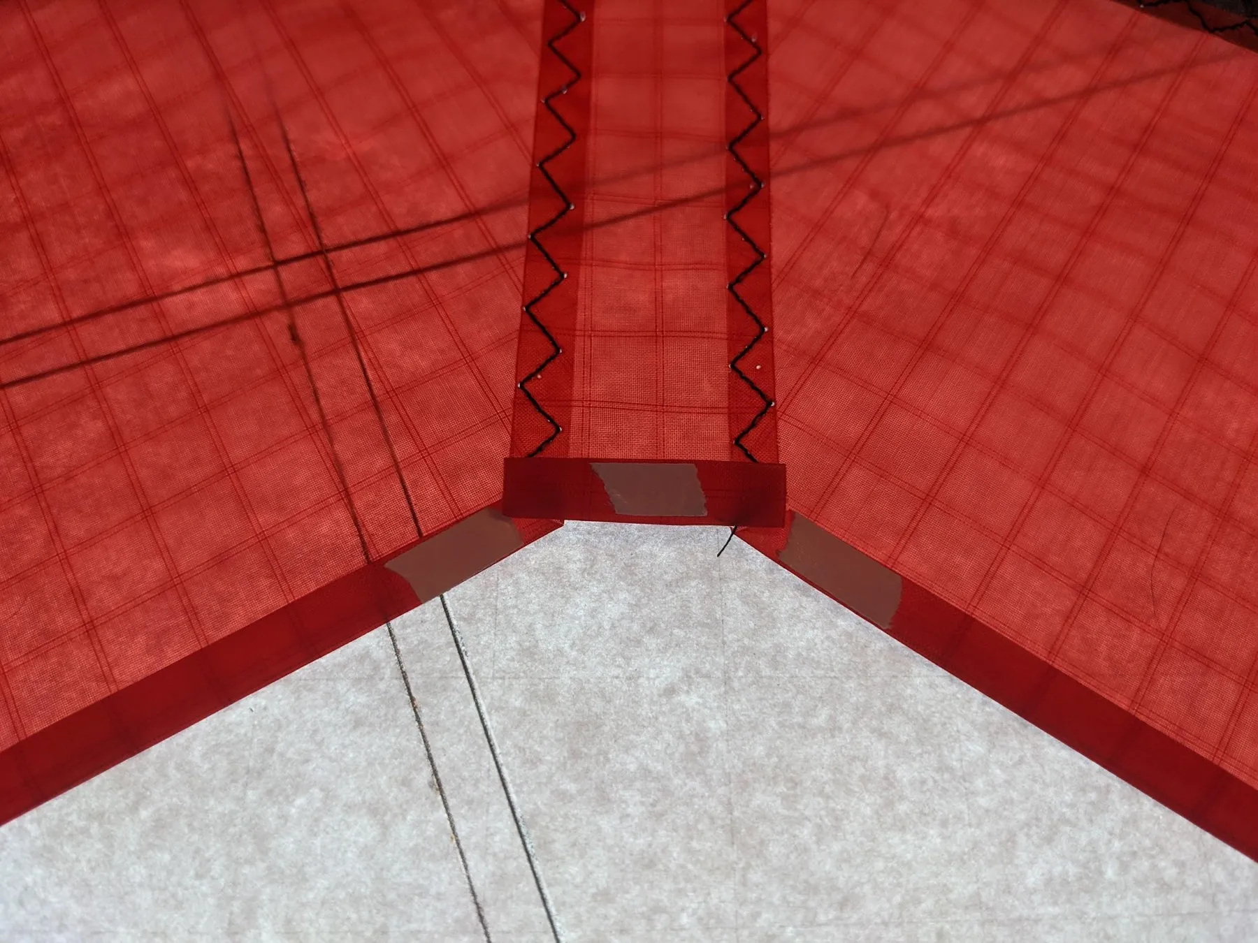 Double-sided tape on the hem around the center V