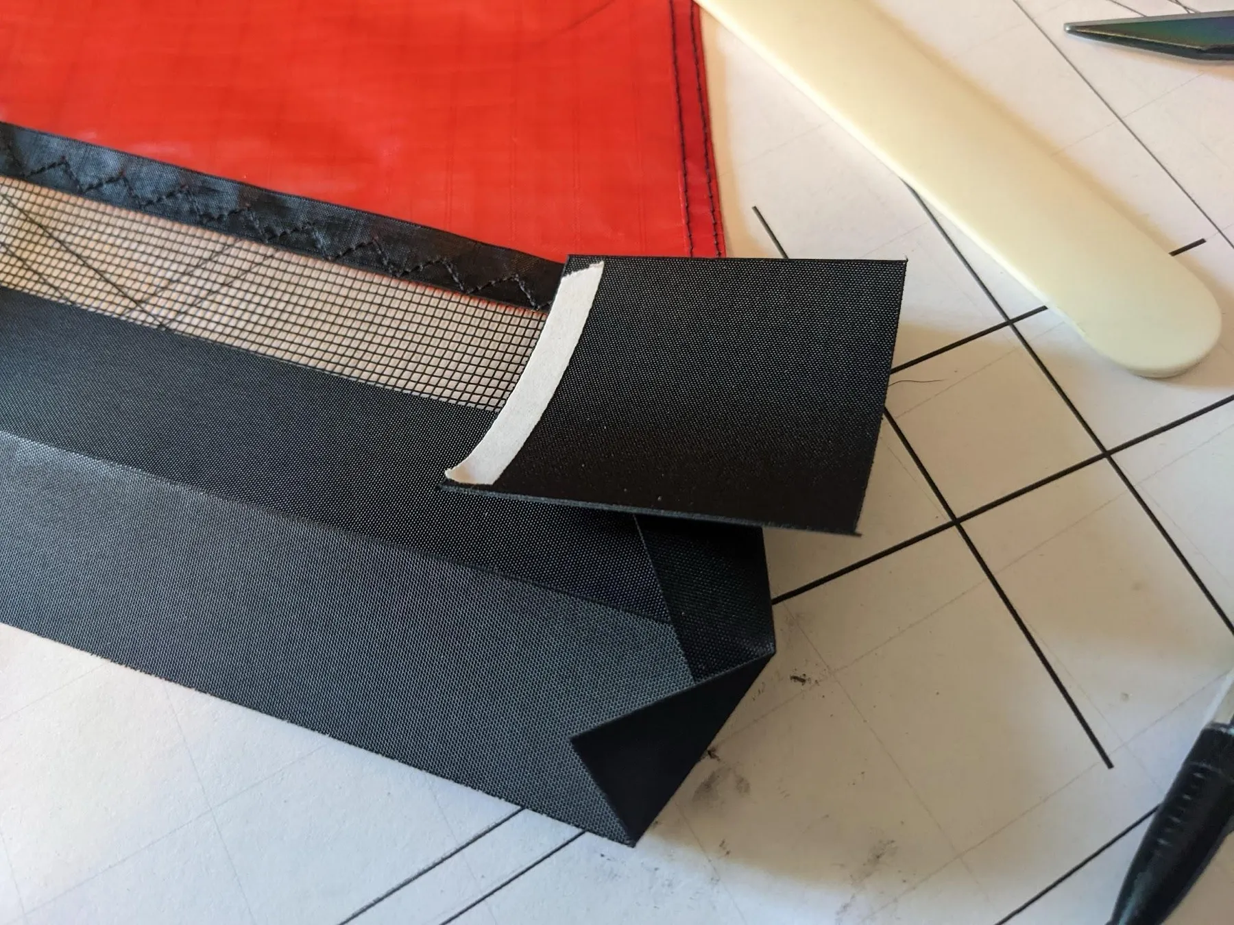 A Dacron square with double-sided tape on one edge