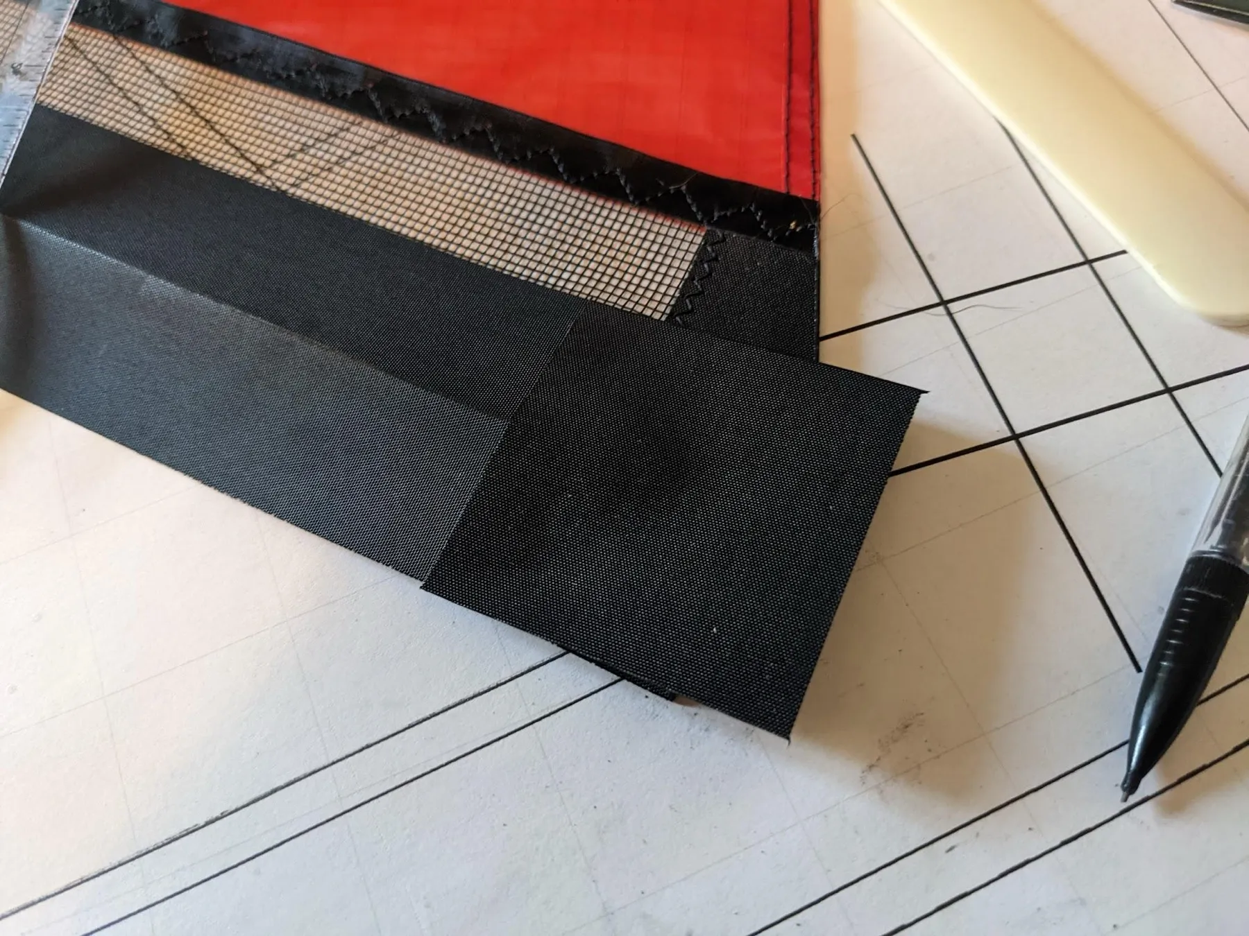 The square laid over the folded end of the leading edge