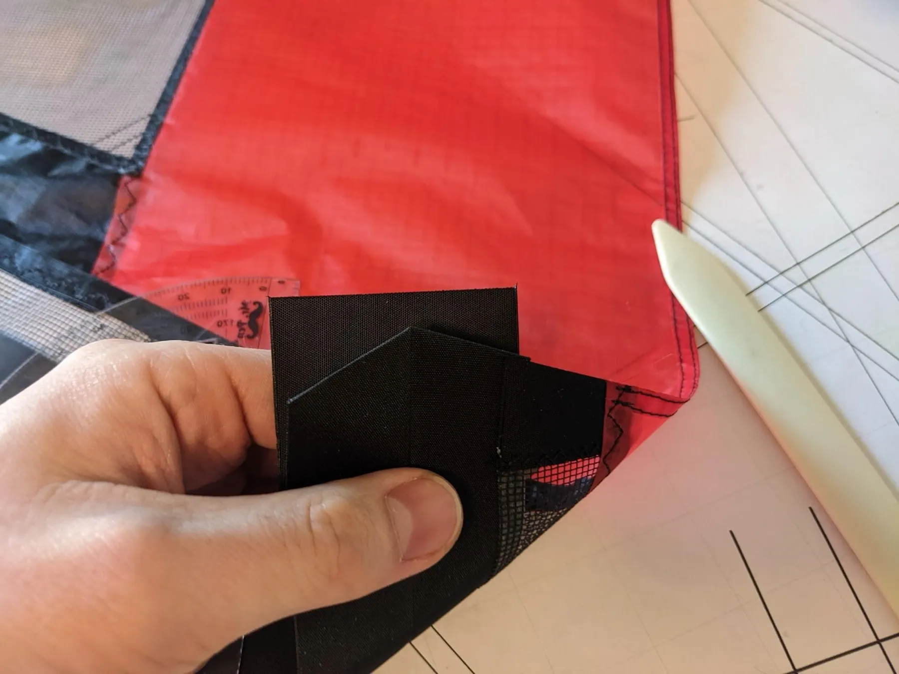 Folding the square around the end so it matches the strip, view 1 of 4