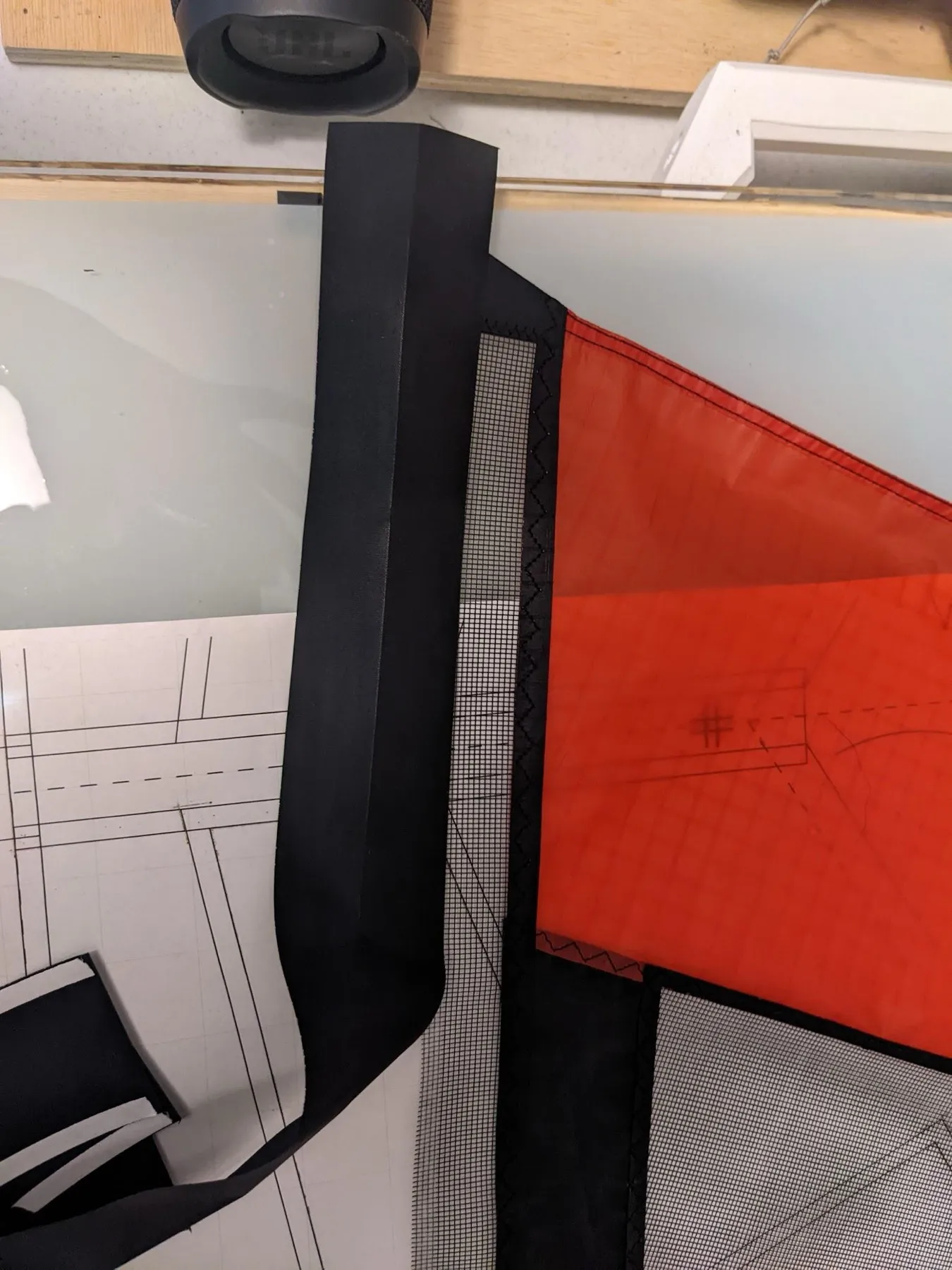 A few centimeters of extra Dacron extend past the edge of the sail