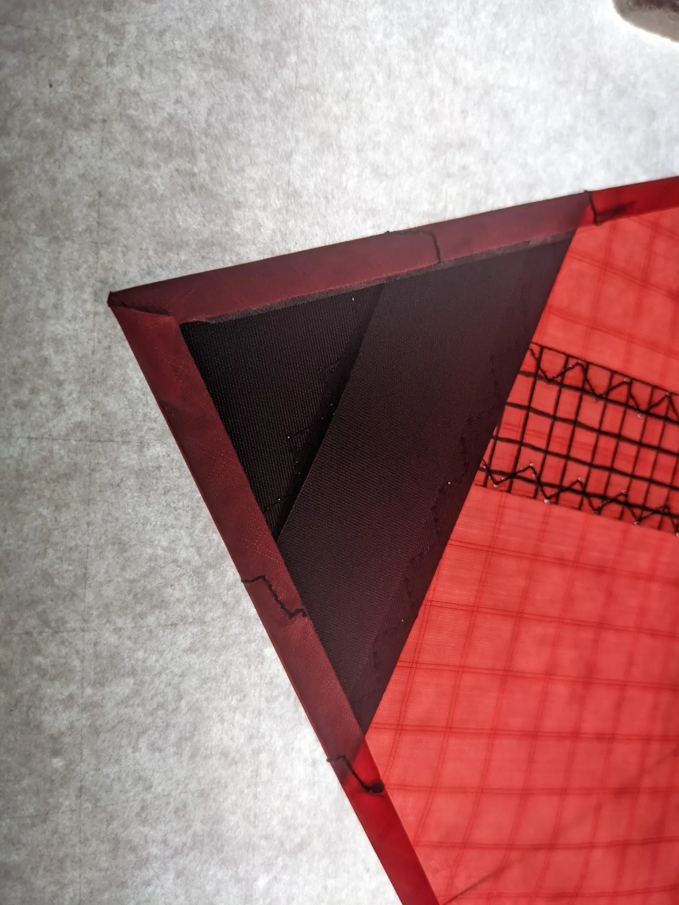 Close view of the folded hem at the left wing tip