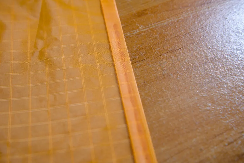 Fold the sail over the trailing edges to make the hems, then sew the hems.