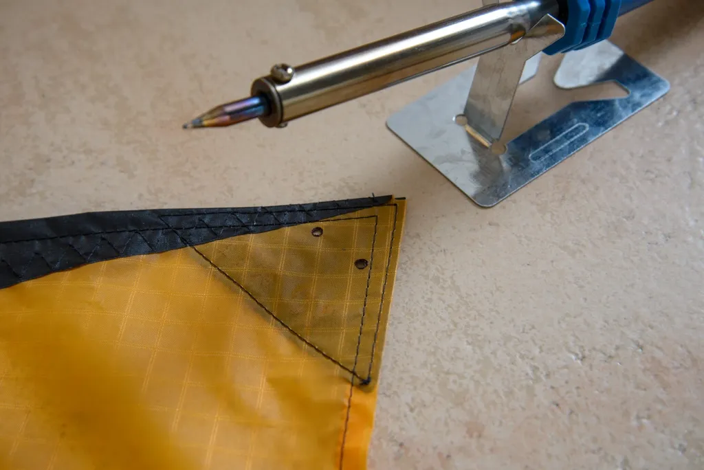 Drilling the sail tips. These holes will hold the bungees.