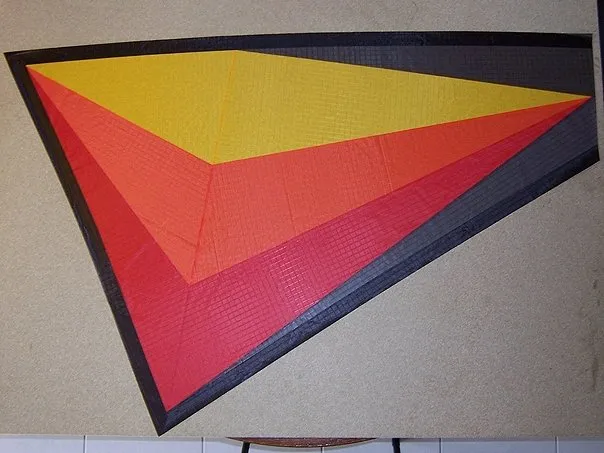 1 wing with black Icarex outline. 3 cm wide. Hem, folded twice, will be 1 cm. Come on, 5 more to go.
