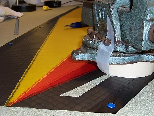 The white Icarex panel is held in place with a weight, then lifted to one side.