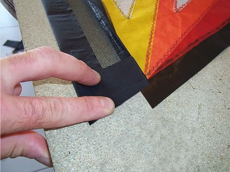 Turn the sail over and cut the black spinnaker along the blue dotted line (in fact, at the leading edge right-stitch seam).