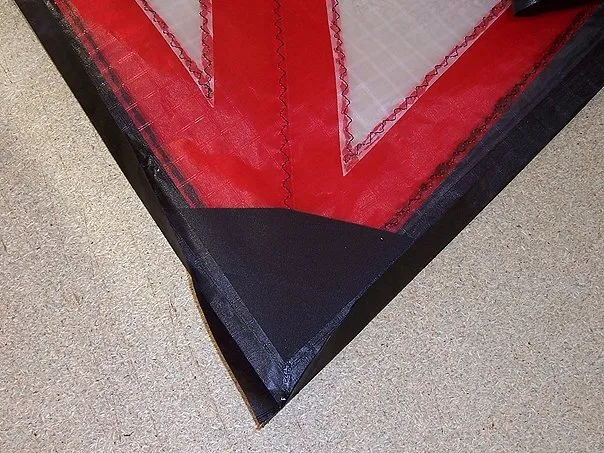 Install the dacron reinforcements for the wing tips + fold the black hems.